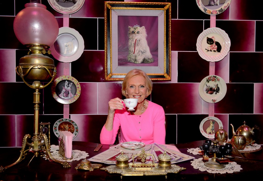 Mary Berry sitting at Dolores Umbridge’s Ministry of Magic desk, featured in the new Dark Arts area at Warner Bros. Studio Tour London – The Making of Harry Potter